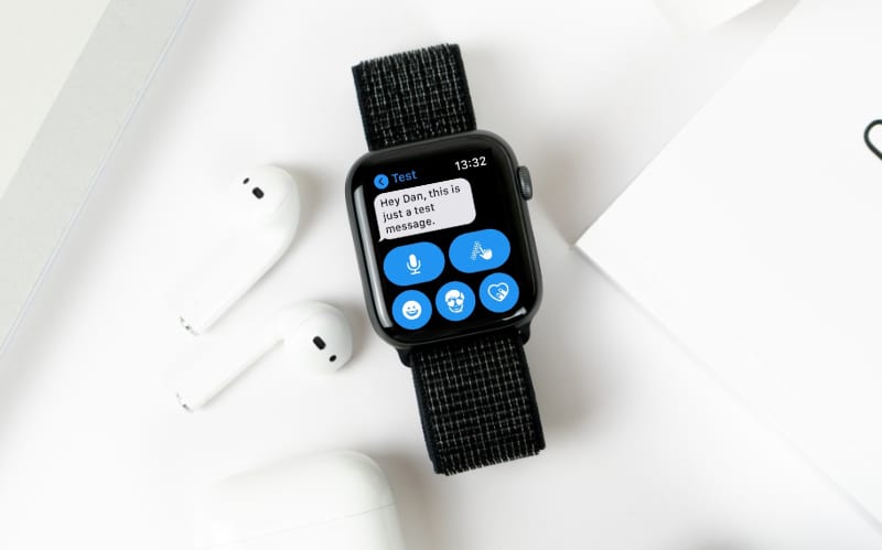 Apple Watch receiving message next to AirPods
